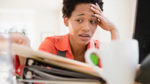 Frustrated African American woman sitting at desk